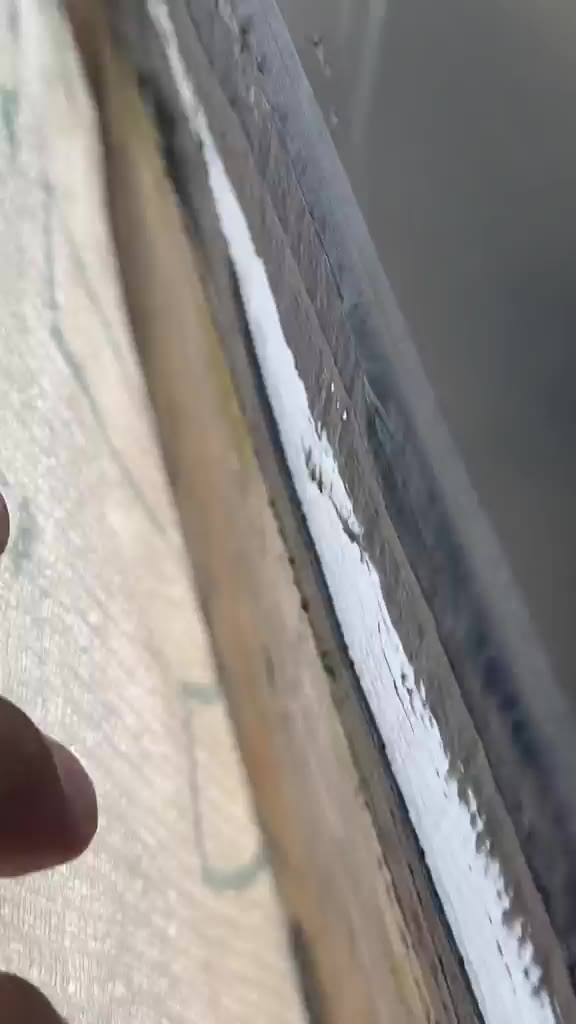 The window jamb flashing (left) and the unsealed edge of the building membrane beside it
