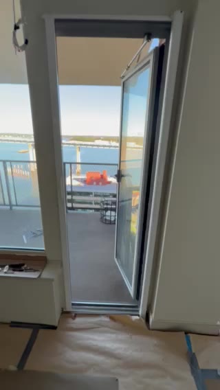 Balcony door screen drawn across from the side