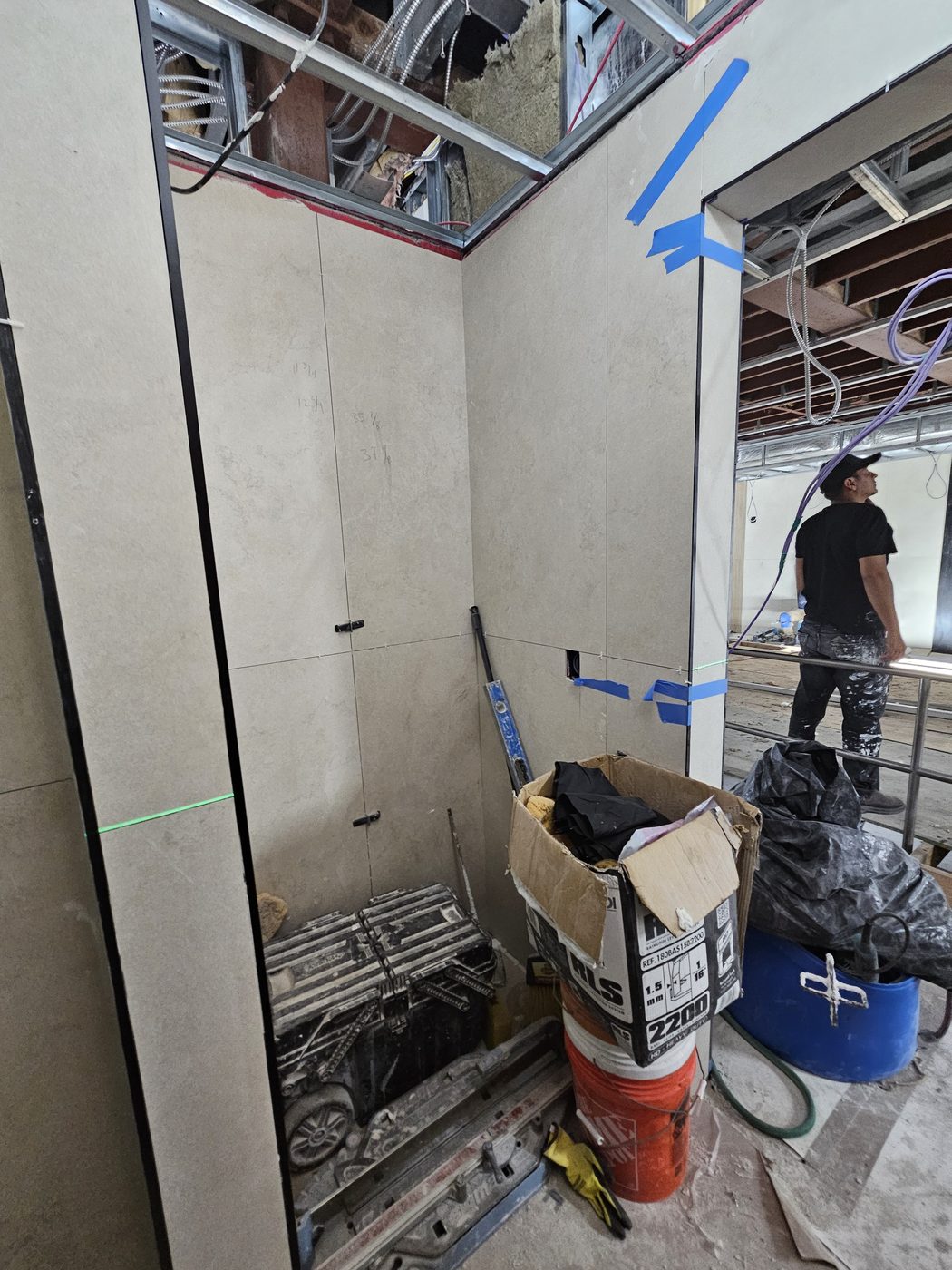 Door opening with field measurements pencilled on the porcelain panels at 2555 Nostrand Avenue, Midwood