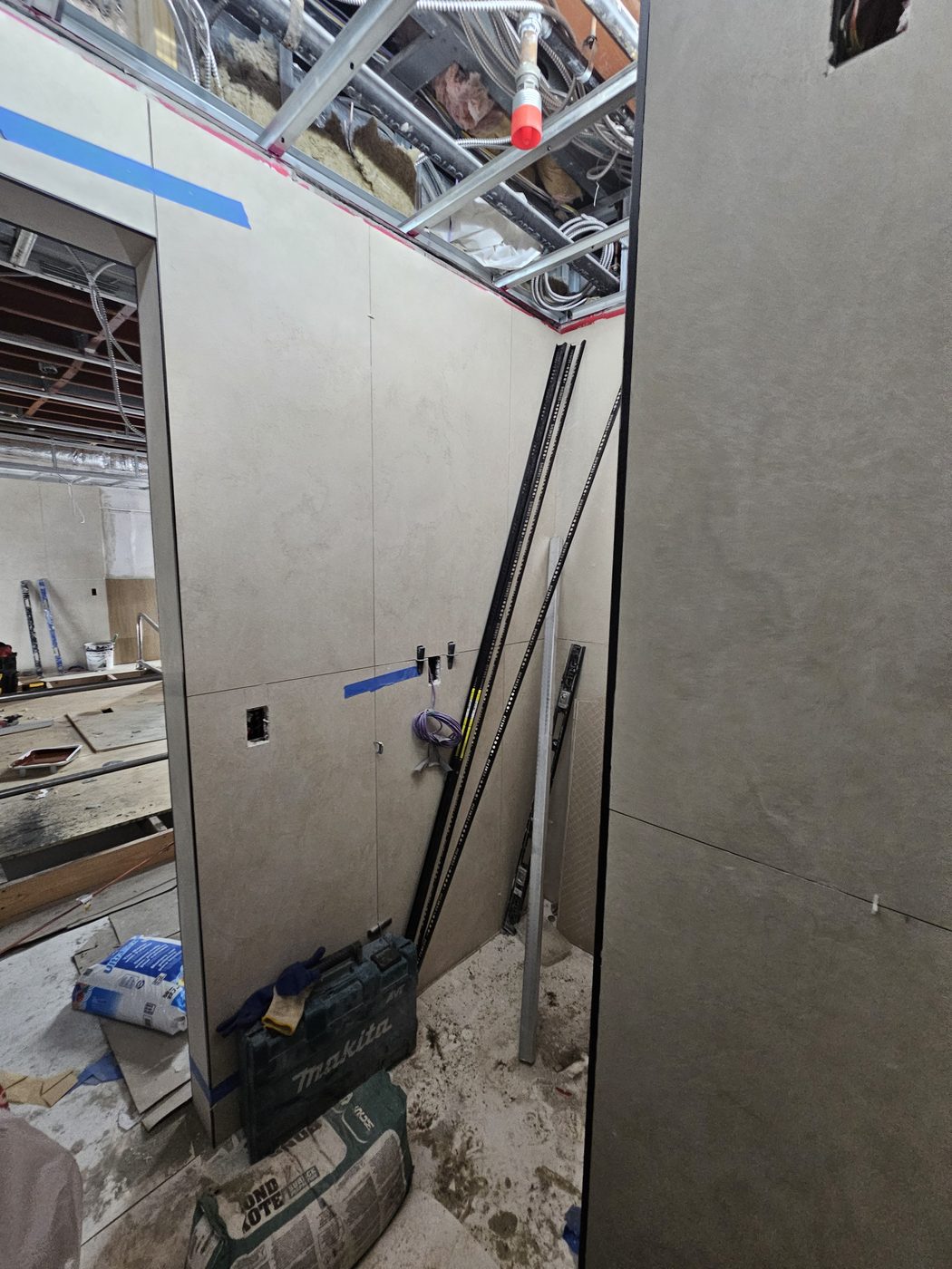 Porcelain-clad bathroom walls with black edge trim before door installation, 2555 Nostrand Avenue, Midwood