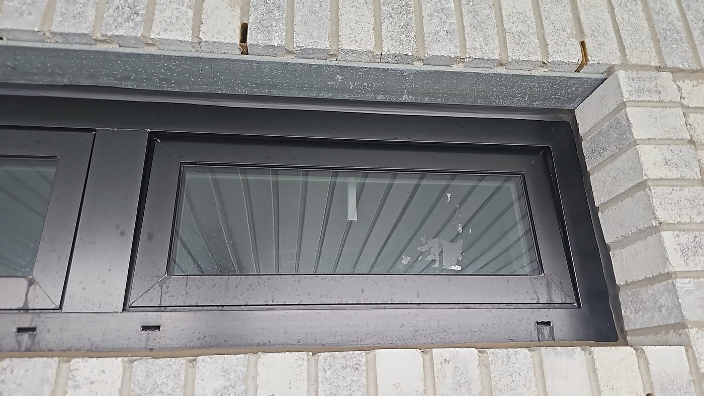 Dark aluminum awning window in Sea Gate, Brooklyn, measured for a custom FlexScreen mosquito screen