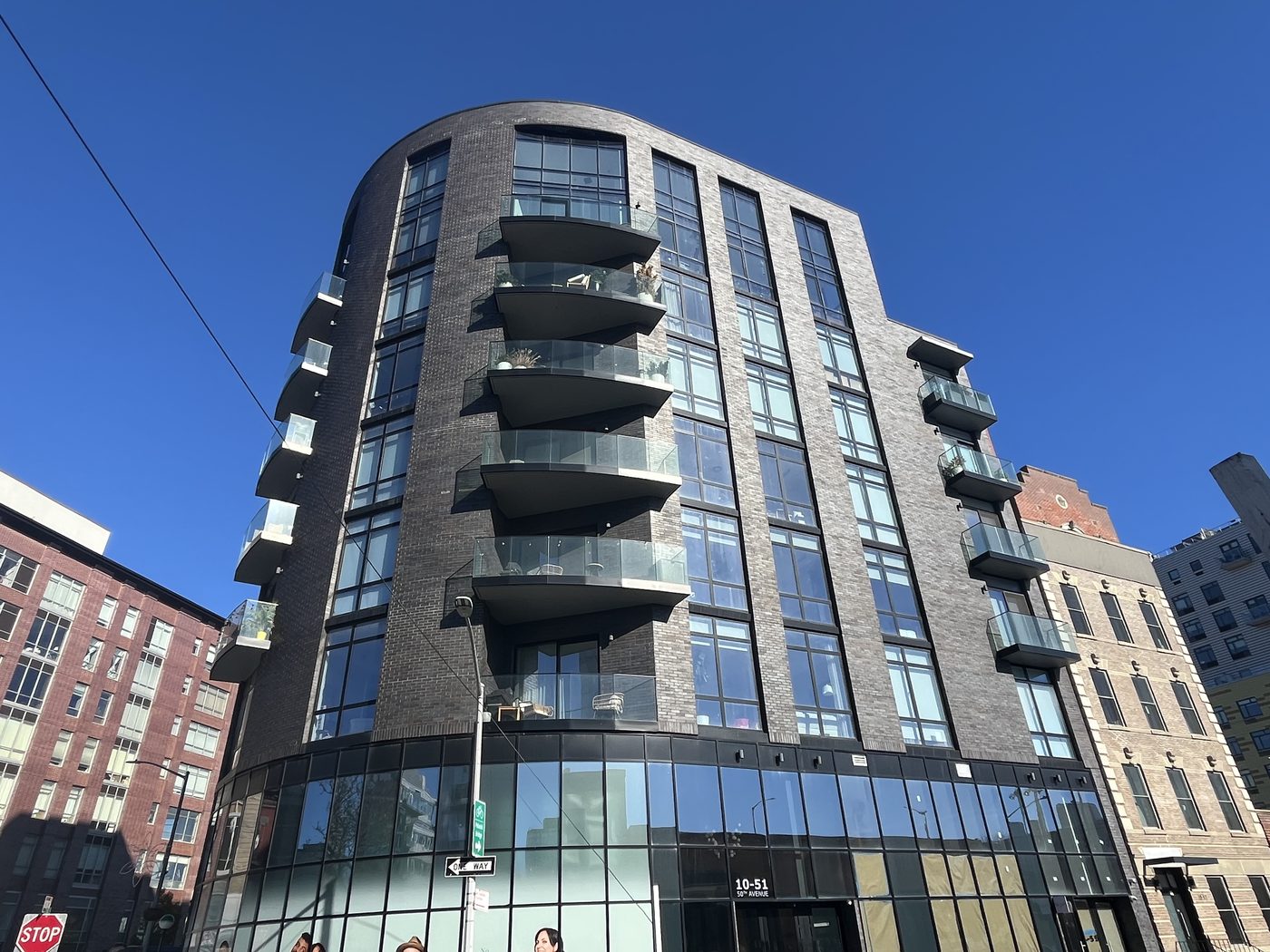 Curved glass balcony railings and tilt-and-turn windows in the curtain wall columns of The Anable