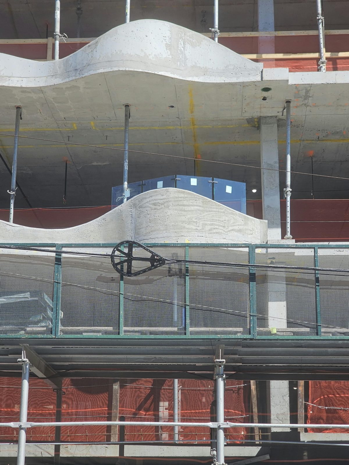 Close view of a wave-form parapet at 1505 Emmons Avenue with the glass guard sample behind it