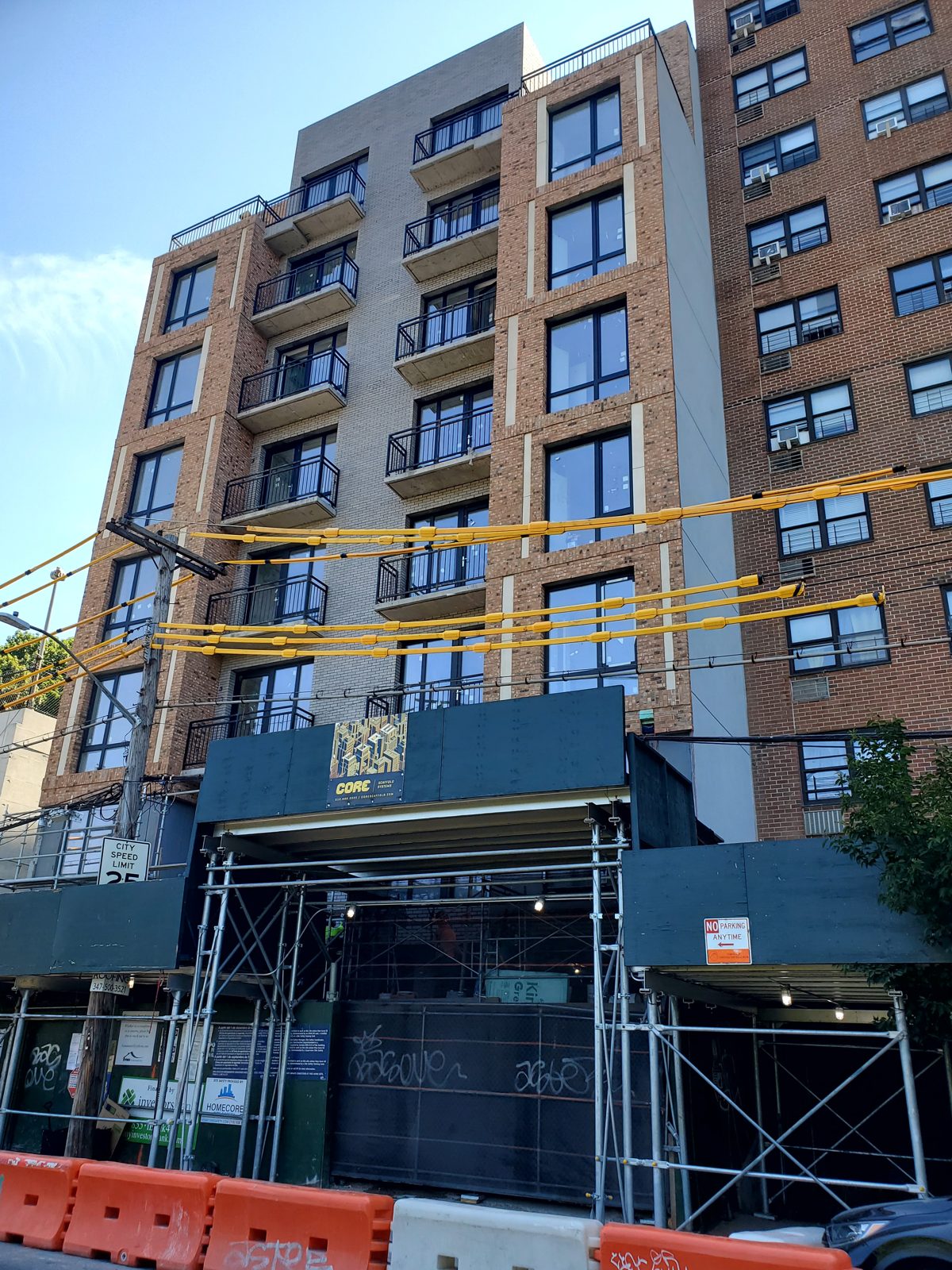 Street front of the new residential building at 1526 Sedgwick Avenue, Bronx, with black-framed windows and balcony doors