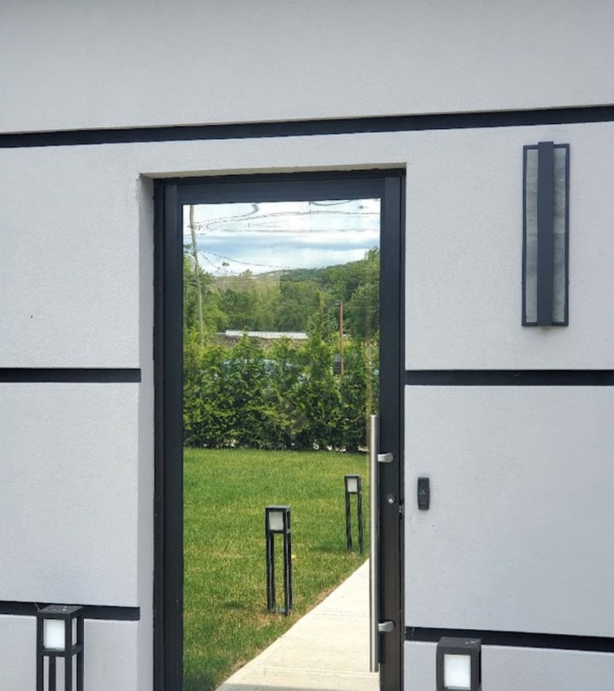 Glazed entrance door in the gray stucco facade of the office building at 1545 Route 202, Pomona, NY