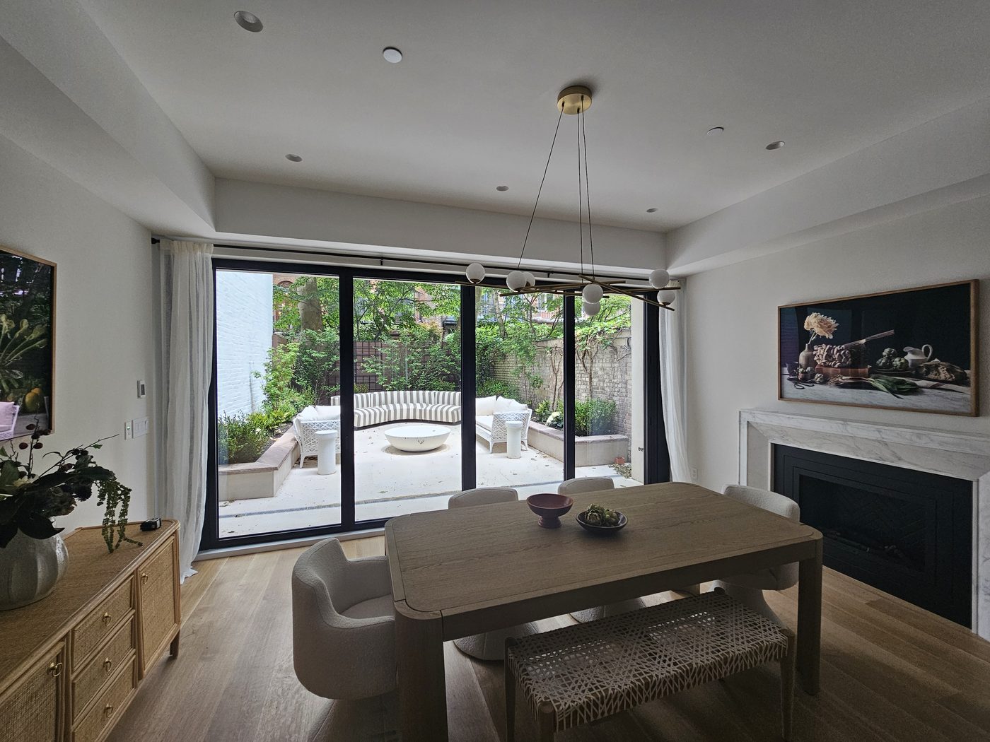 Dining room at 165 East 64th Street with sliding glass doors to the planted garden