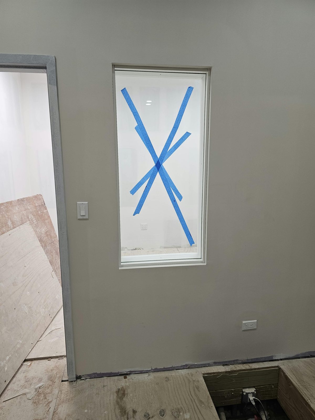 Soundproof interior window at a church at 1763 Amsterdam Avenue, Hamilton Heights: half-inch laminated glass lites with a three-inch airspace, white frame, finished wall
