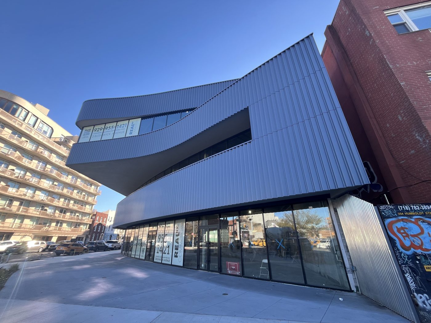 Side elevation of 2 Bushwick Avenue showing curved glazing under the corrugated cladding