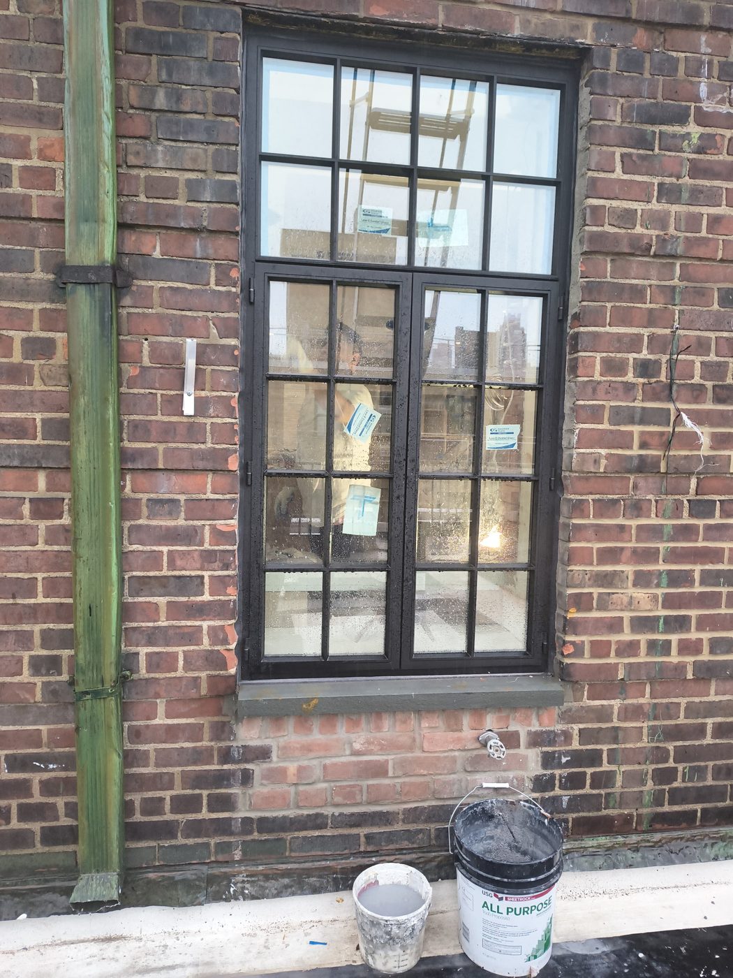 New custom thermally broken steel casement window with transom and divided lites in the brick facade of the 205 East 69th Street penthouse