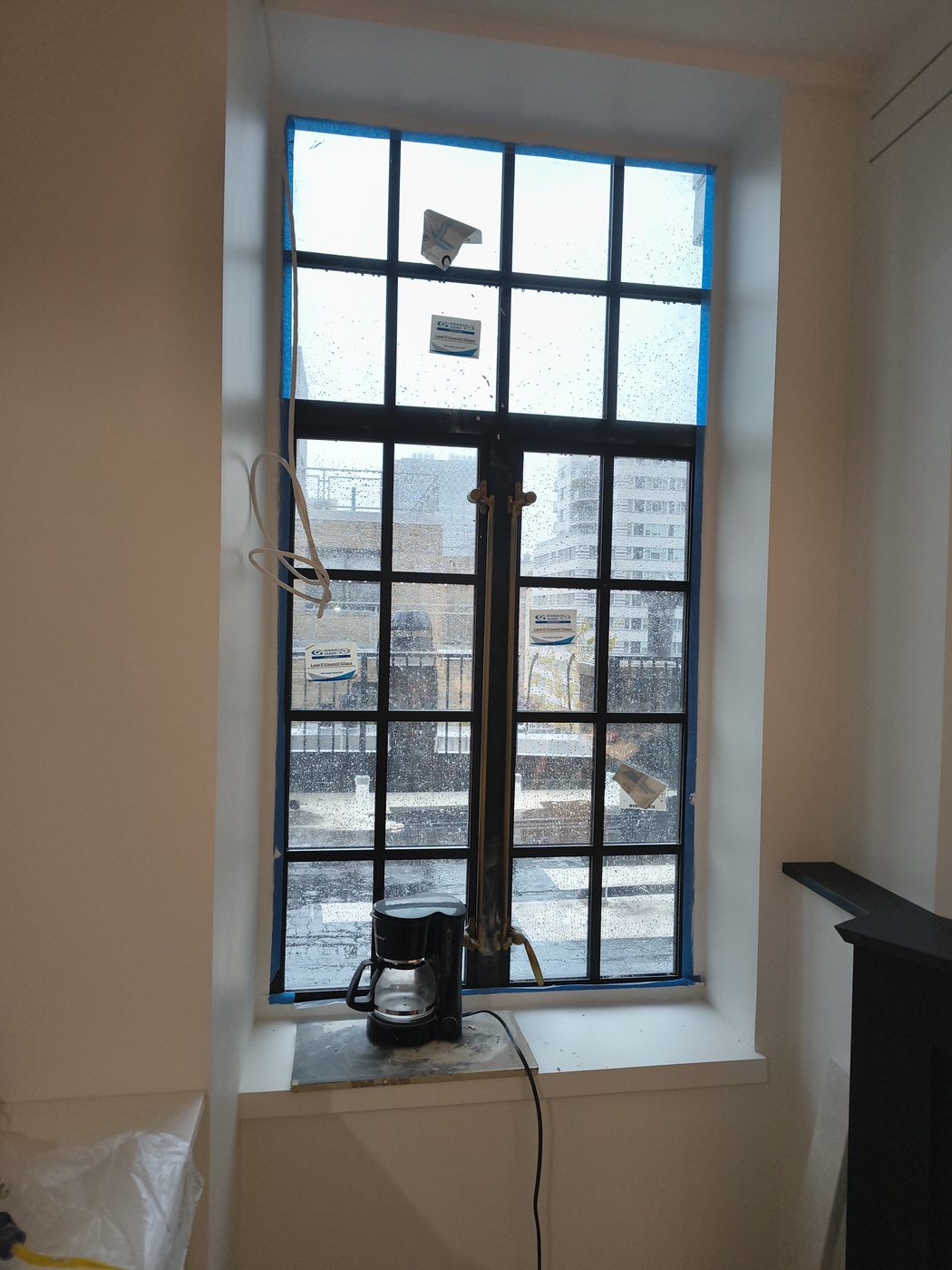 Steel casement window with transom in a deep plastered reveal inside the penthouse at 205 East 69th Street