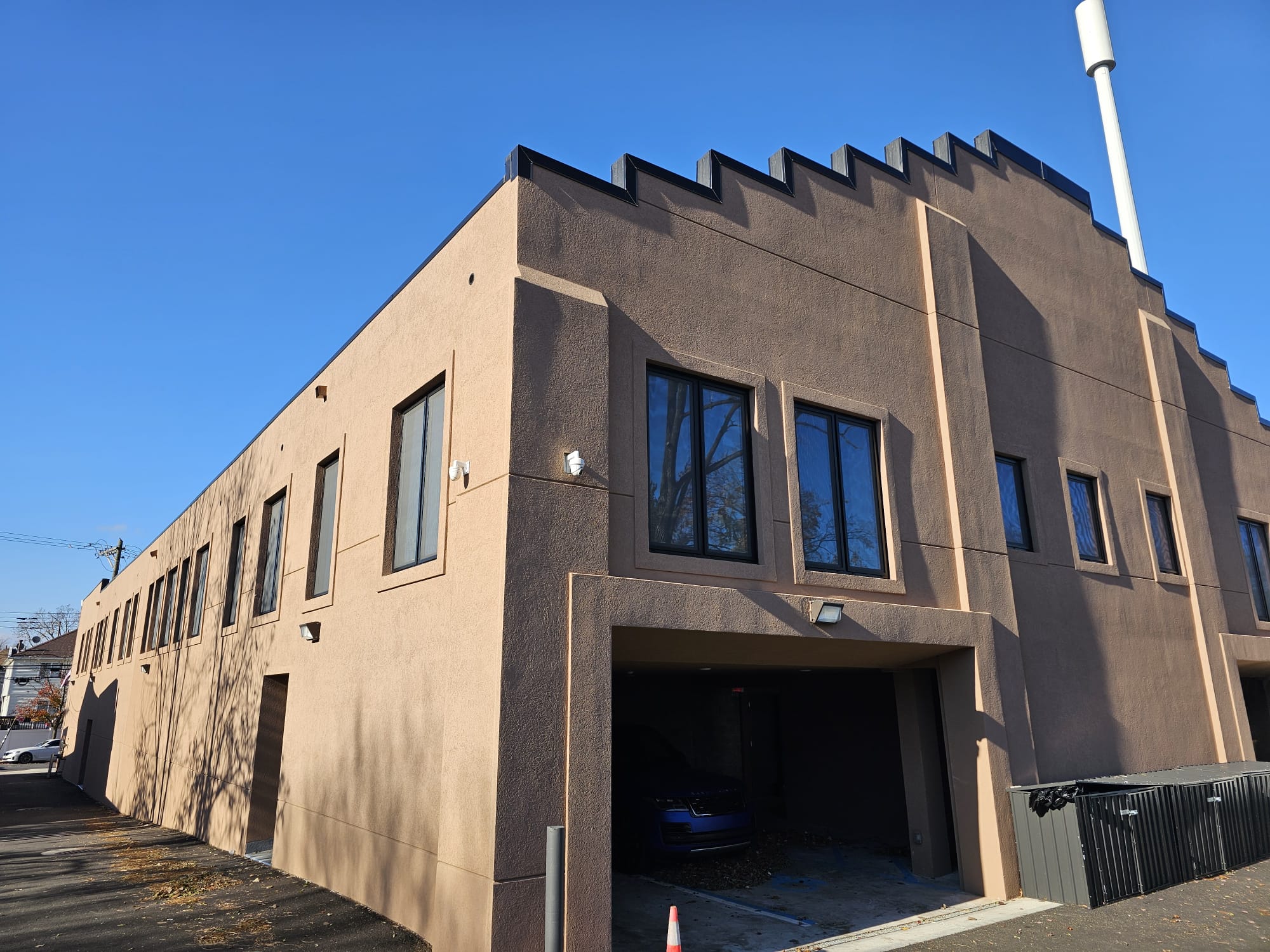 Commercial facade with black aluminum windows at 217 Main Street, Staten Island