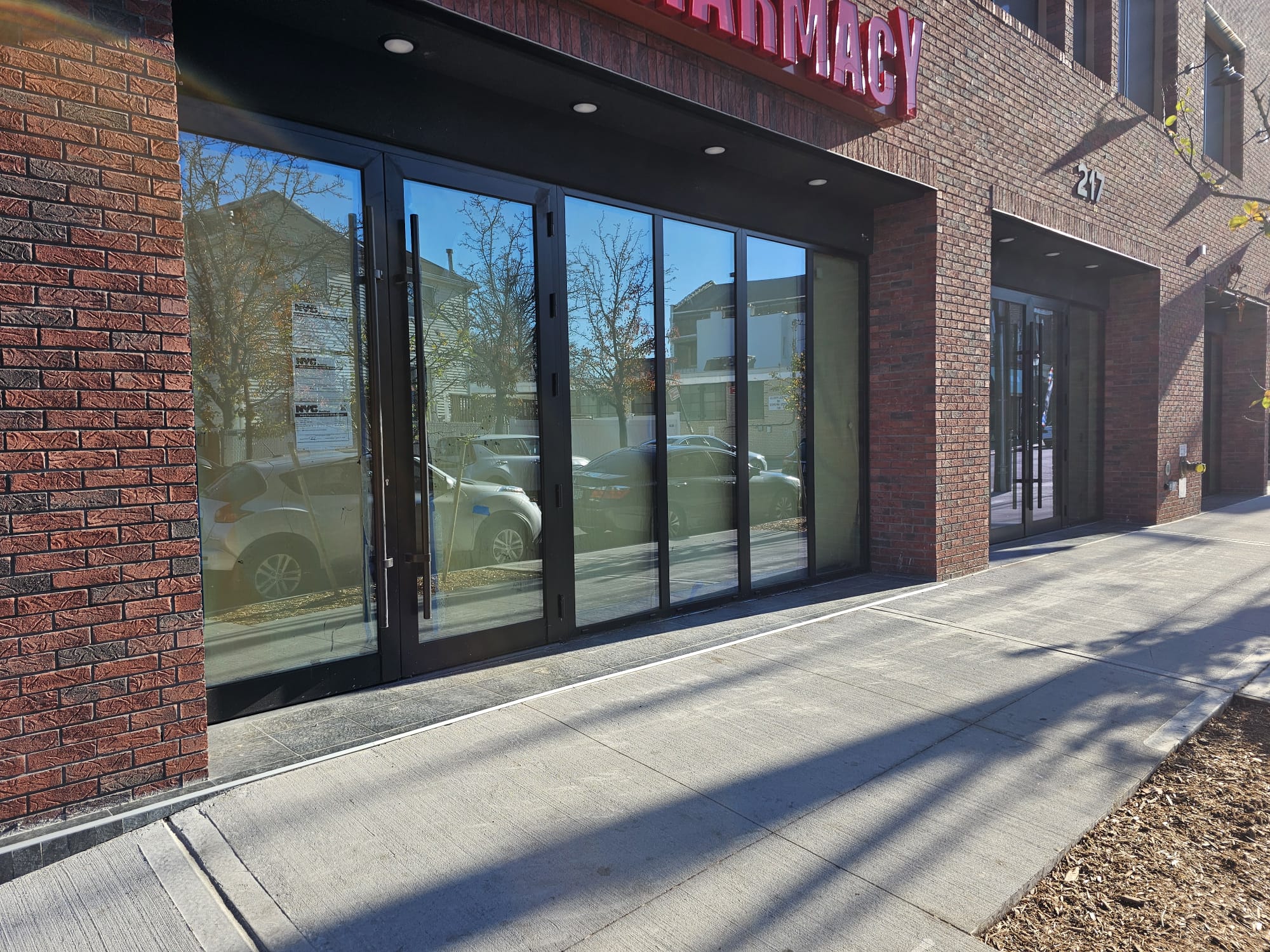 Black aluminum storefront doors at 217 Main Street, Staten Island