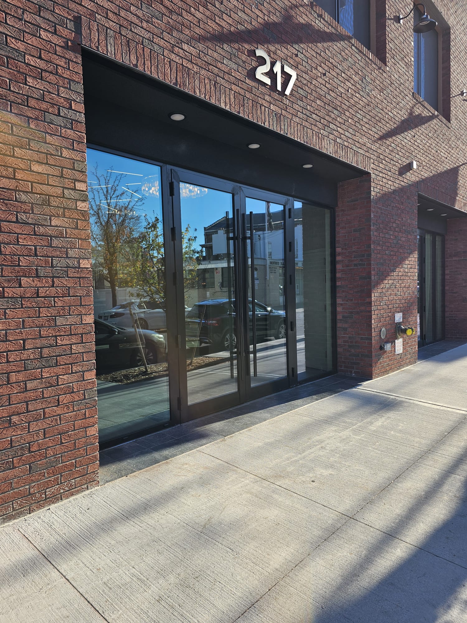 Storefront door installation detail showing the weatherproofed perimeter, 217 Main Street, Staten Island