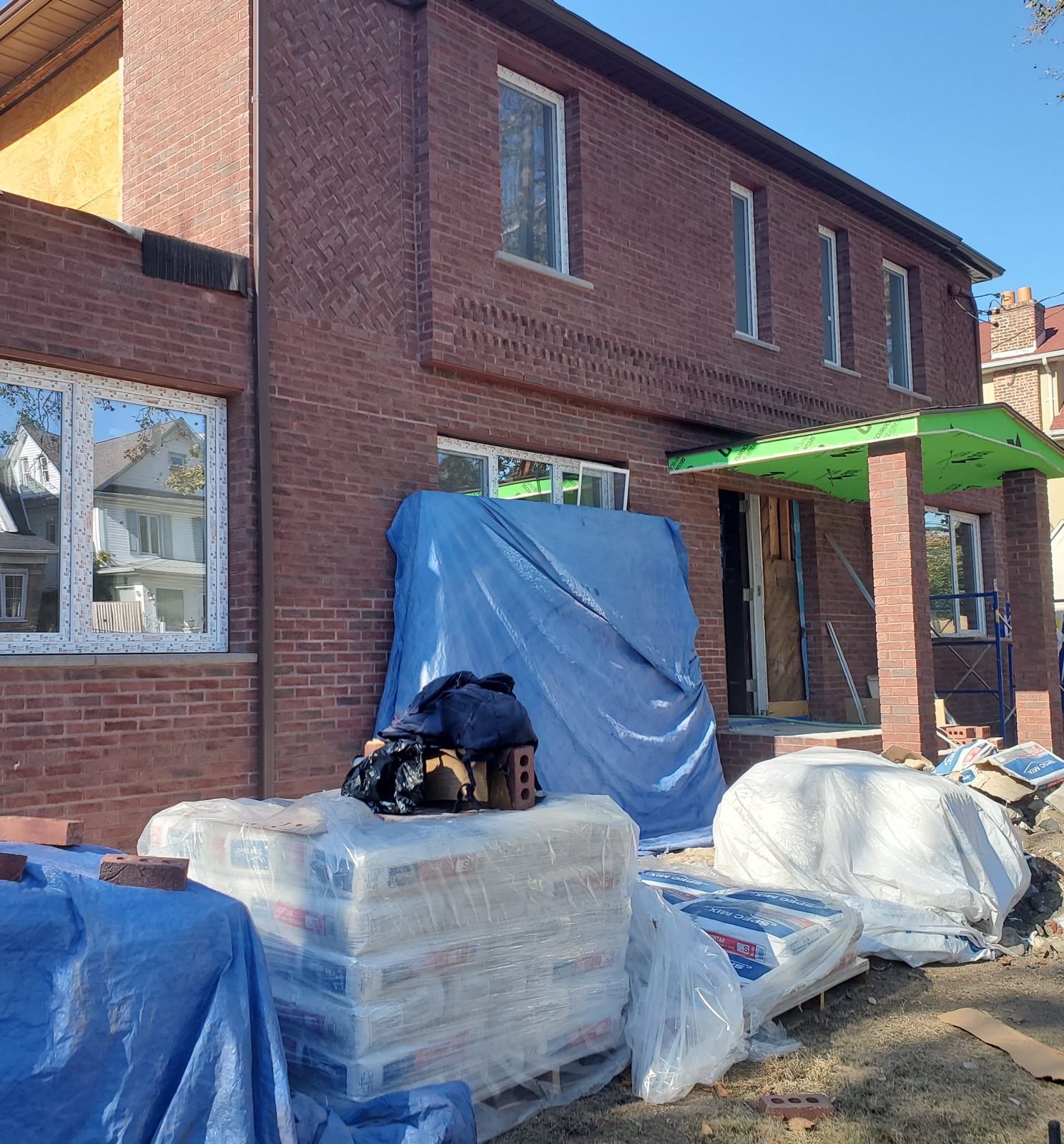 White uPVC windows on both floors of the brick side elevation at 24 74th Street, Brooklyn