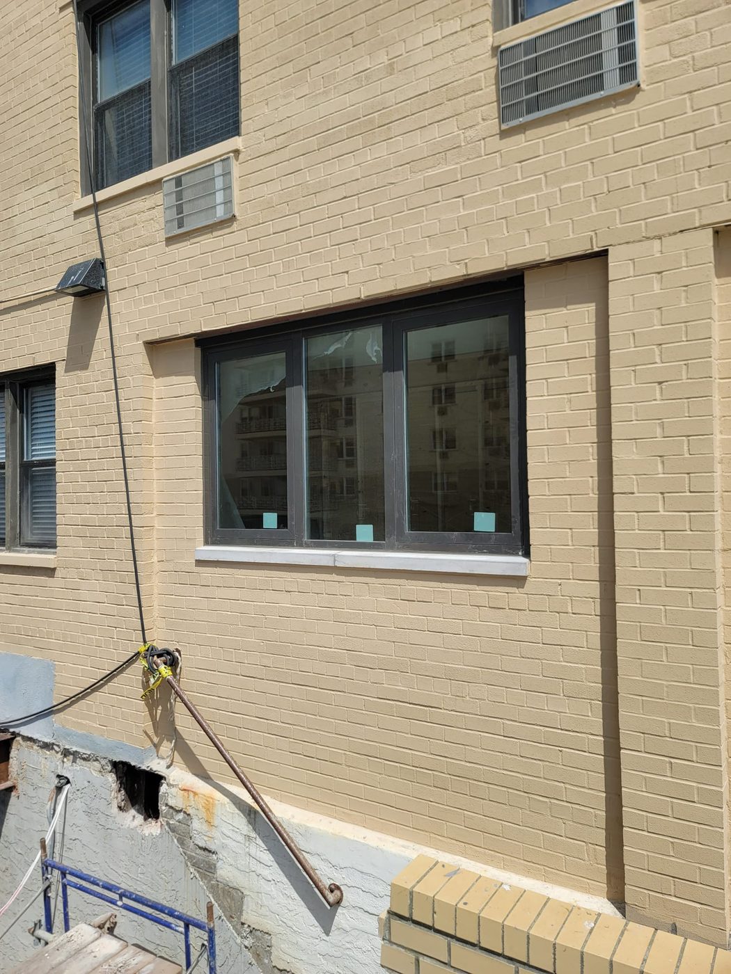 Brick elevation of 25 Franklin Boulevard with new dark aluminum double-hung windows on four floors