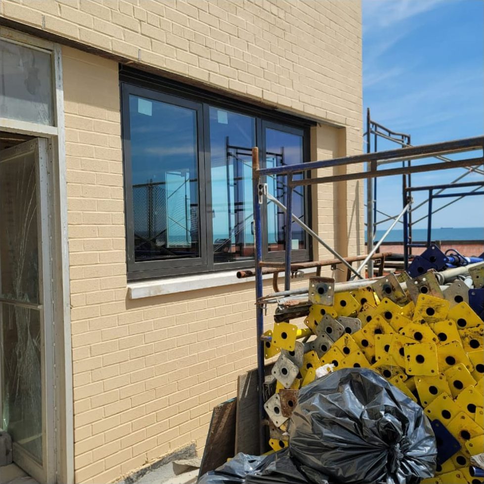 New aluminum window at 25 Franklin Boulevard with the scaffold and the Atlantic Ocean behind