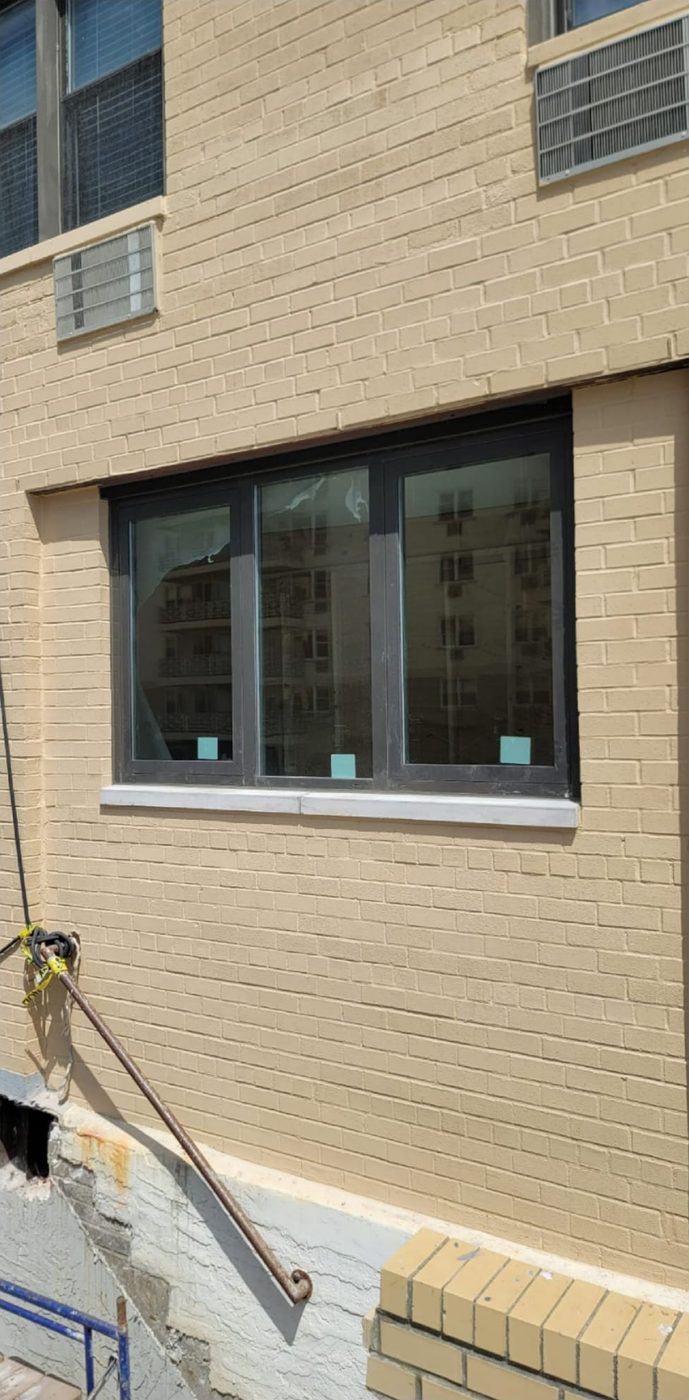 Triple aluminum window installed at terrace level in painted brick at 25 Franklin Boulevard