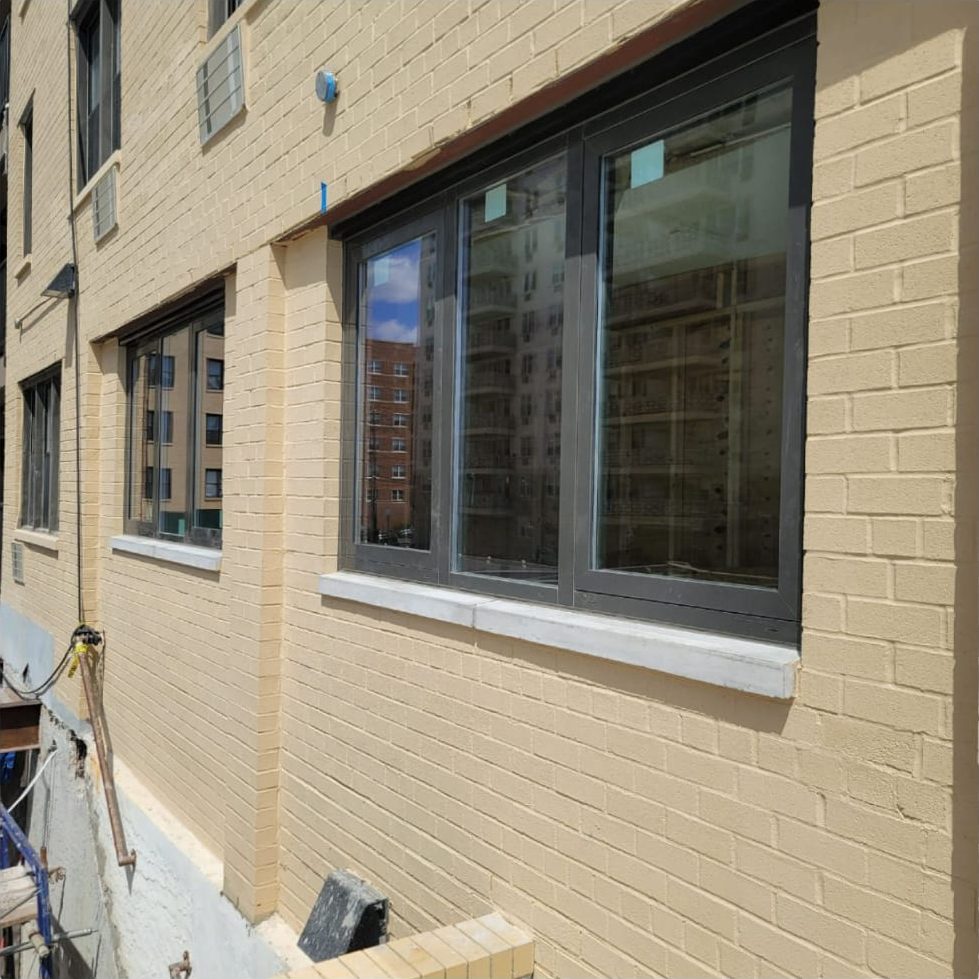 Run of new tilt-and-turn aluminum windows along the side facade of 25 Franklin Boulevard
