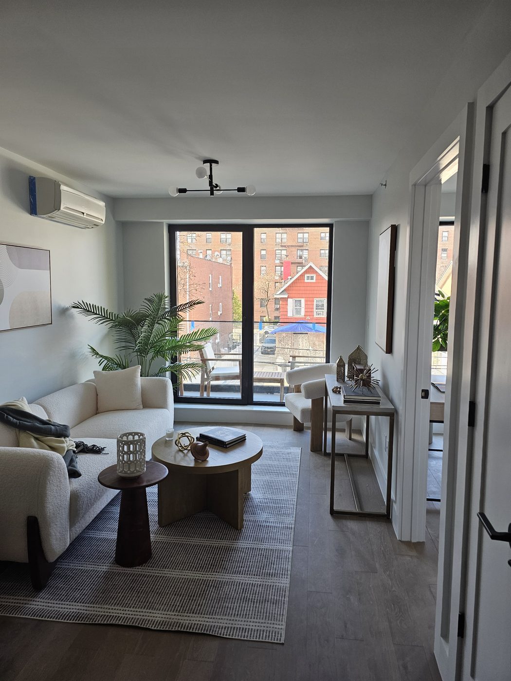 Living room interior with full-height aluminum balcony door opening onto the terrace, 2518 Ocean Avenue, Brooklyn