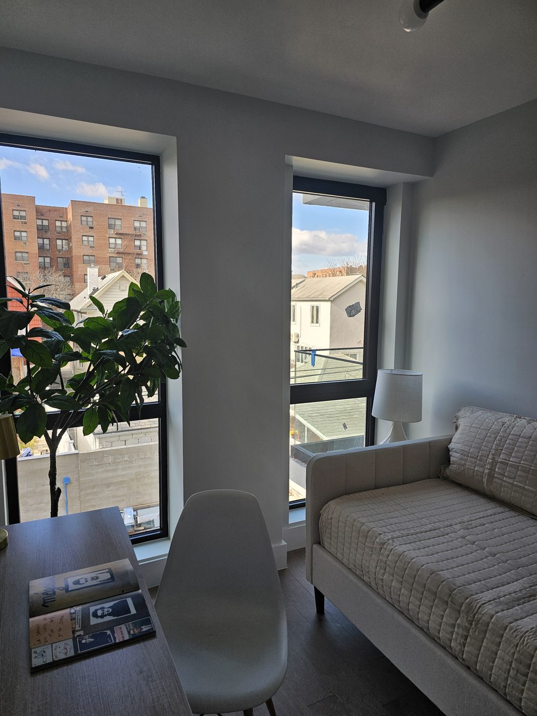 Bedroom with tall fixed and operable aluminum windows in dark frames, 2518 Ocean Avenue, Brooklyn