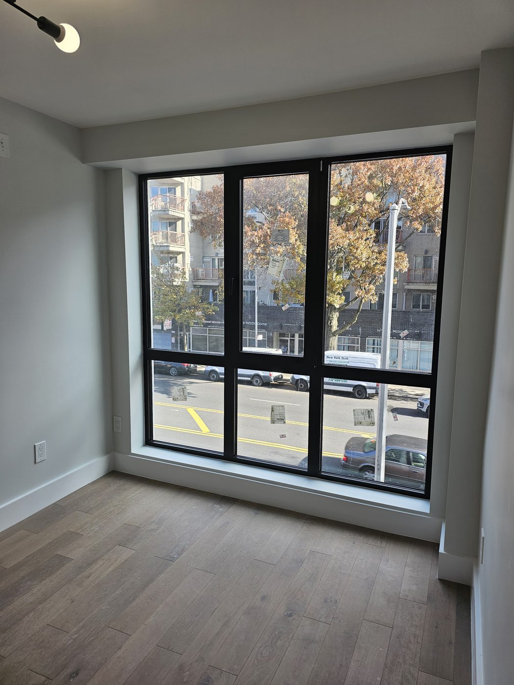 Three-lite aluminum window with operable centre sash seen from inside, 2518 Ocean Avenue, Brooklyn