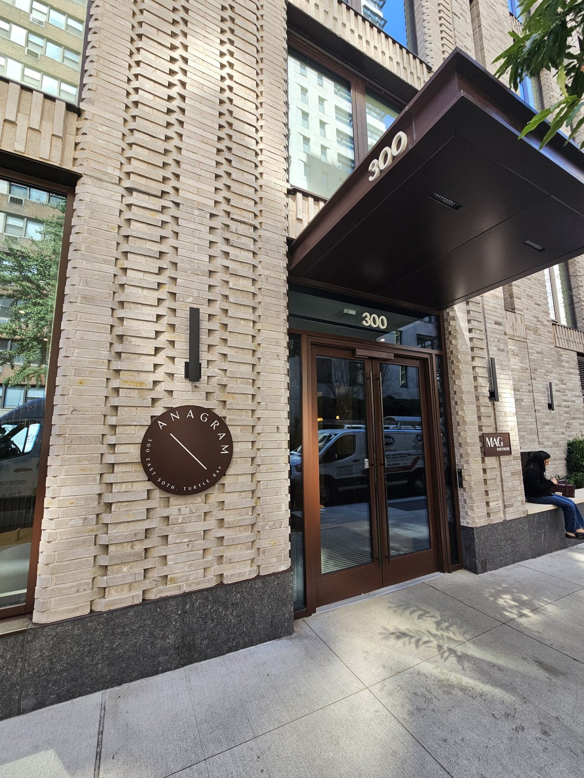 Entrance canopy wrapped in aluminum composite panels above new entry doors and curtain wall at 300 East 50th Street, Turtle Bay, Manhattan