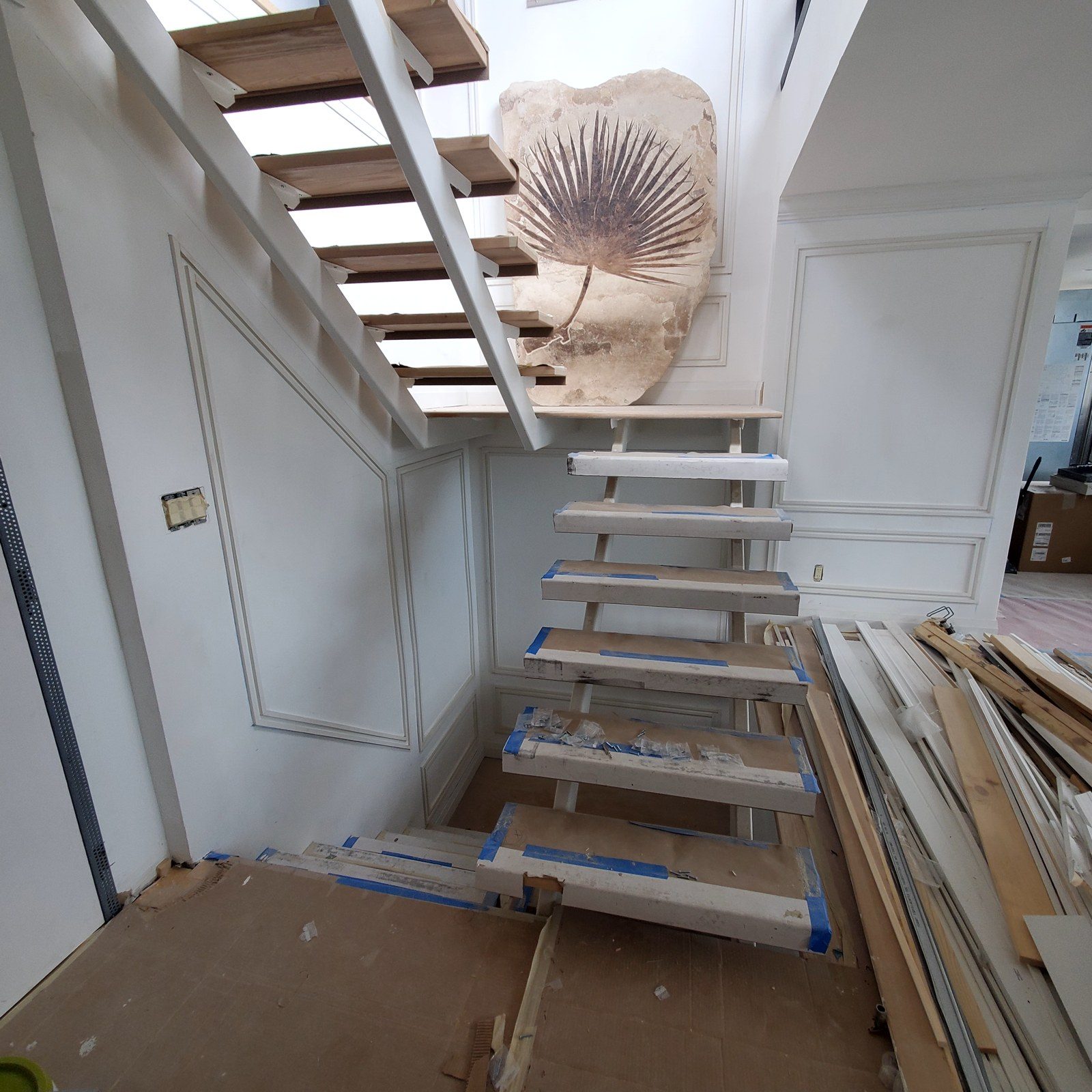 Open-riser staircase with protected treads and no railing, before the glass railing was installed, in a penthouse at 300 East 90th Street, Manhattan
