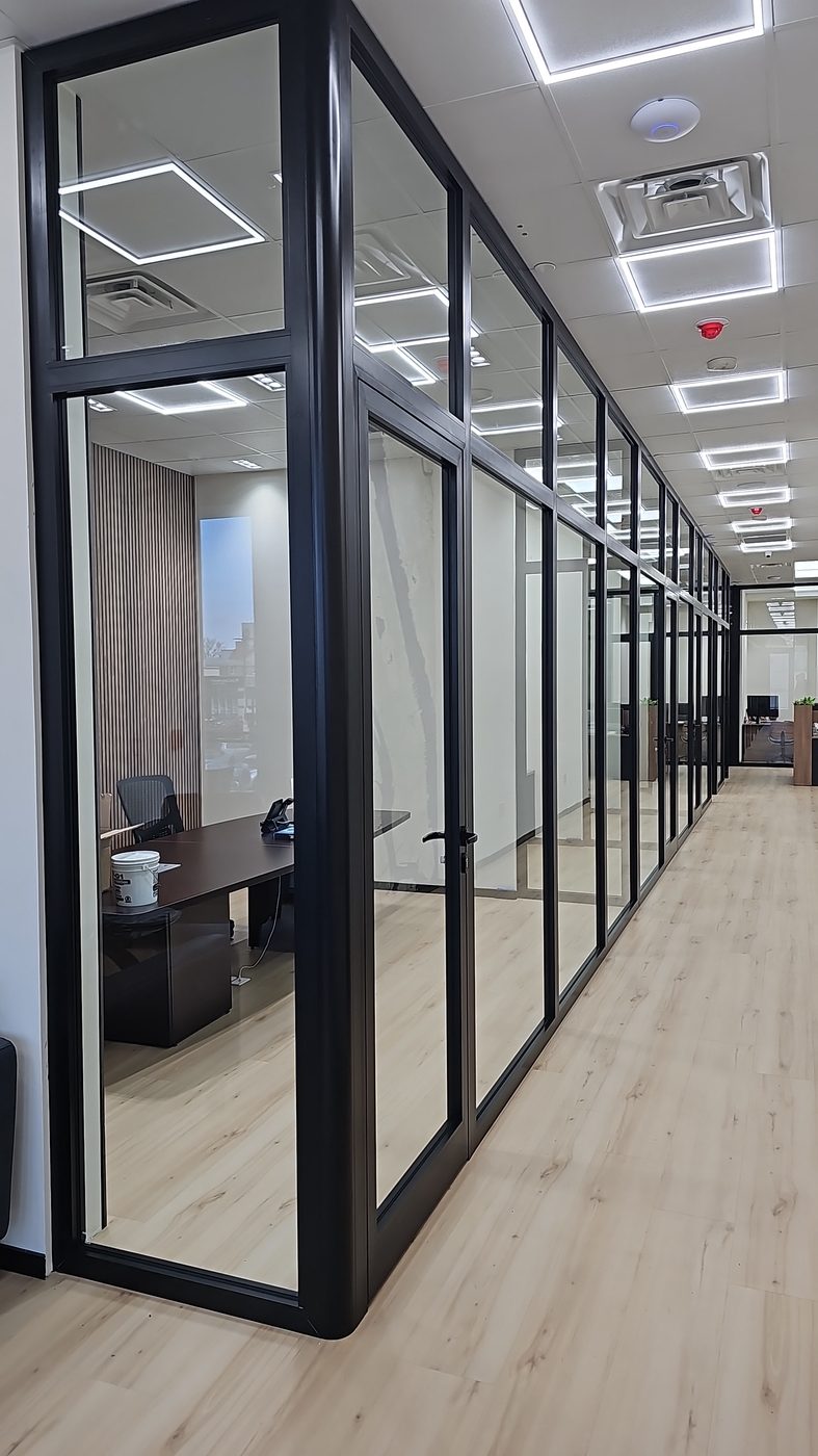 Corridor of floor-to-ceiling black aluminum and glass office partitions with glass doors at 3121 Ocean Avenue, Sheepshead Bay