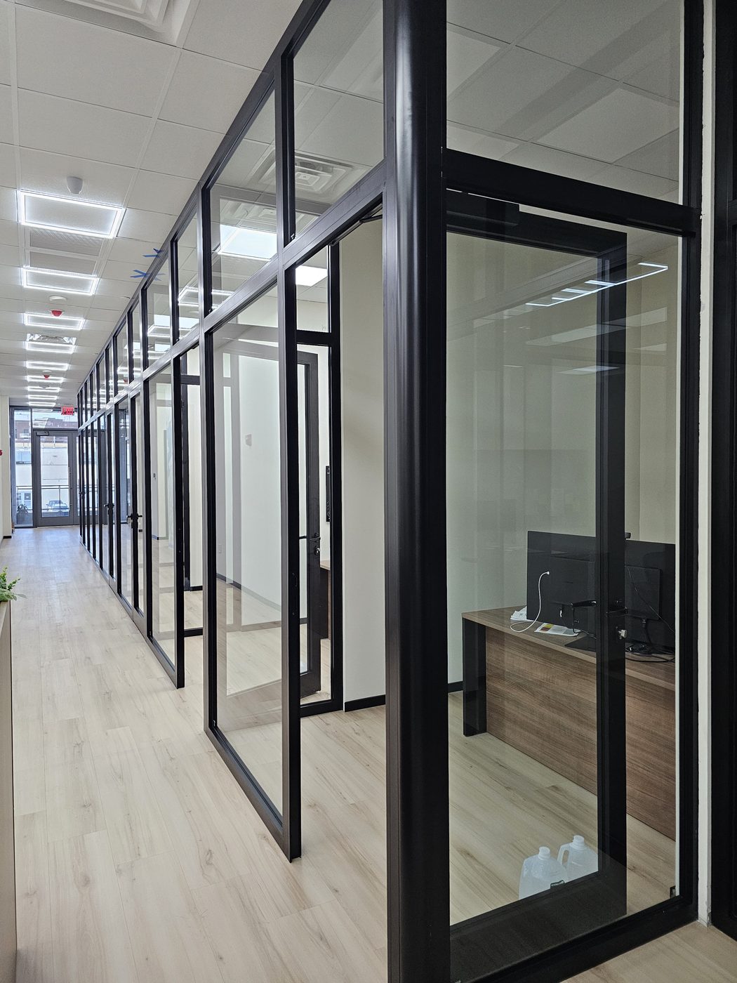 Office hallway with glass fronts and open aluminum door at 3121 Ocean Avenue, Sheepshead Bay