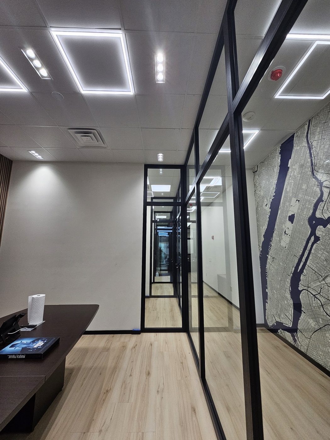 Inside an office looking out through the floor-to-ceiling glass wall at 3121 Ocean Avenue, Sheepshead Bay