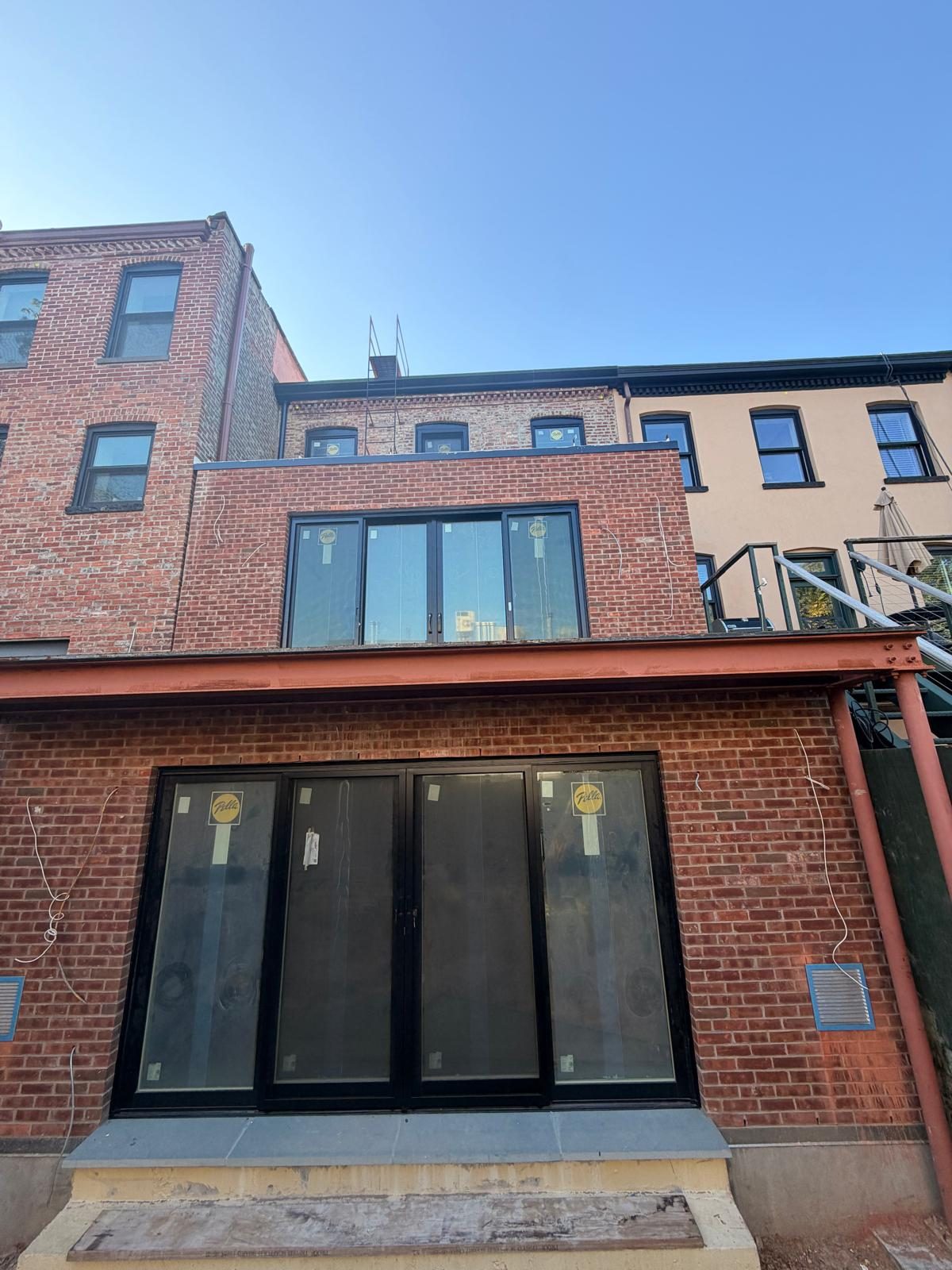 Rear elevation of 343 Hoyt Street with Pella sliding doors at garden and parlor levels and windows above