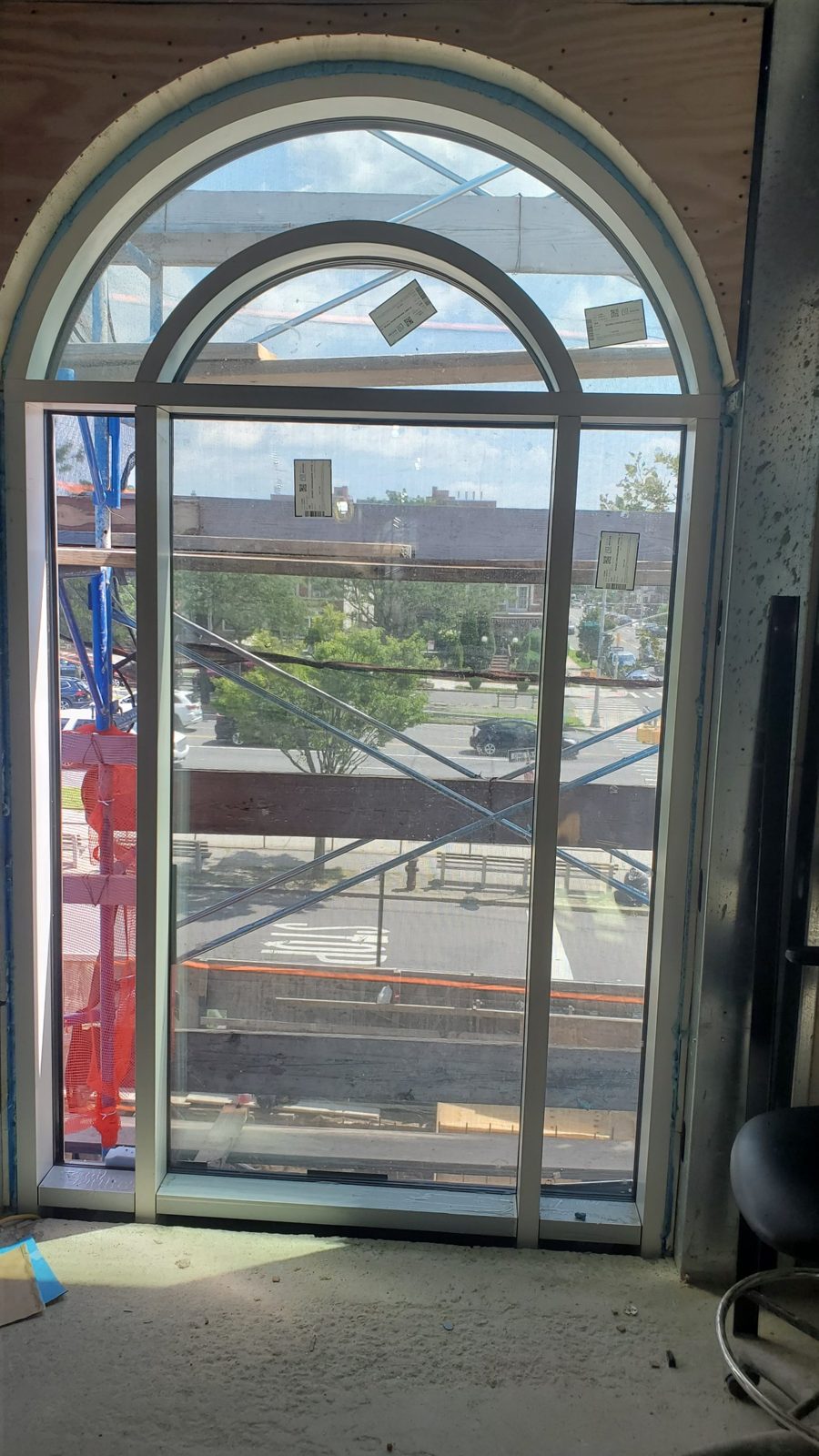 Arch-shaped aluminum curtain wall unit with a tall fixed center light and concentric inner arch at 4 Jim Lynch Drive, Long Branch NJ