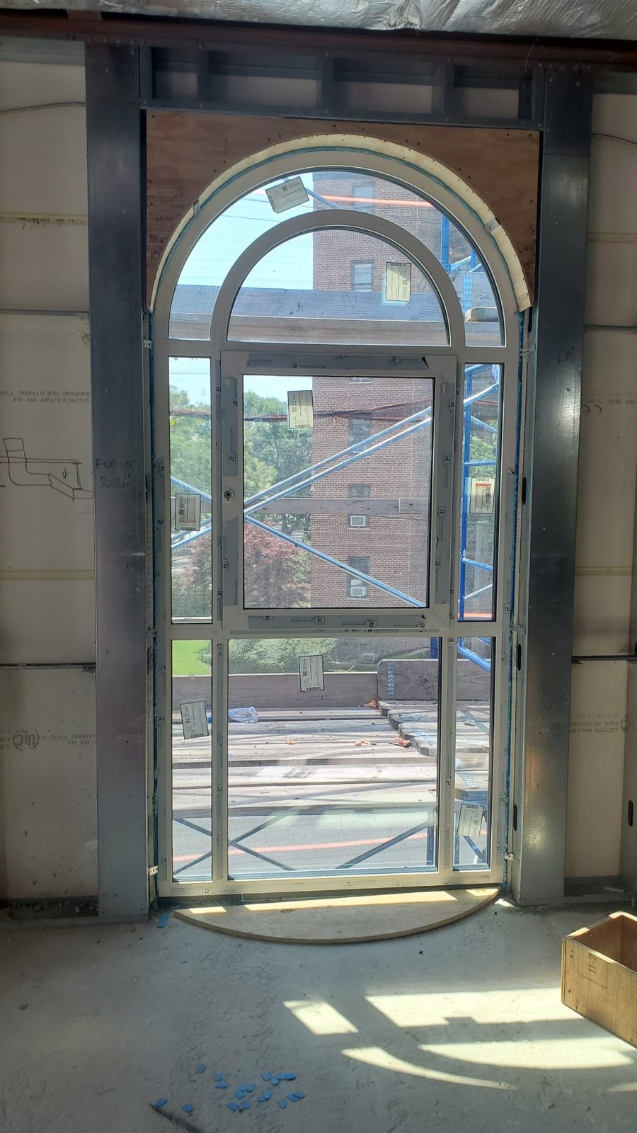 Arch-shaped aluminum curtain wall unit with an opening window in the center bay at 4 Jim Lynch Drive, Long Branch NJ