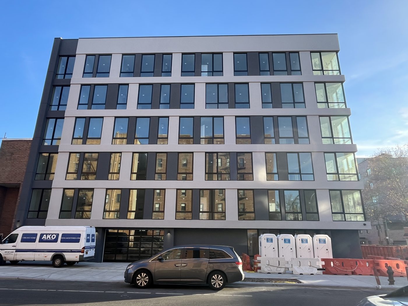 Lefferts Avenue elevation of 408 Lefferts Avenue with paired aluminum windows on all six floors and garage below