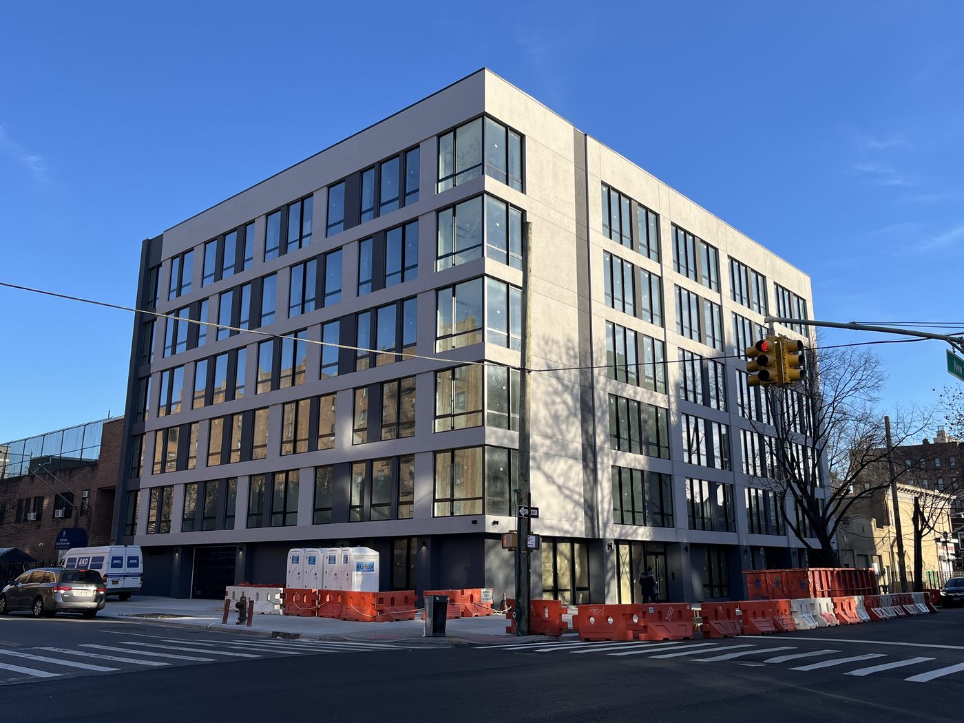Facade of 408 Lefferts Avenue in afternoon light showing the window grid and corner units