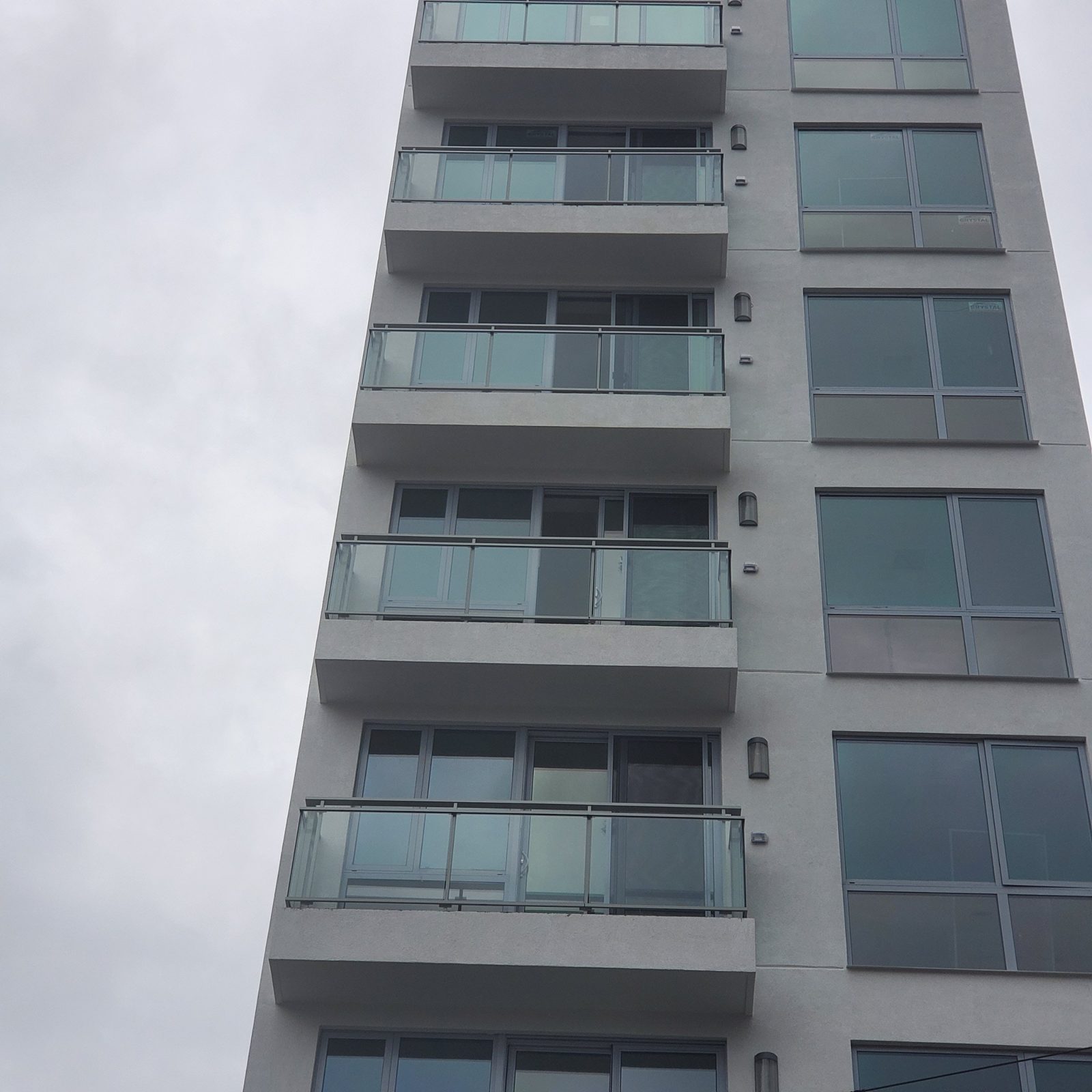 Stack of balconies with aluminum post and glass railings at 42-44 Crescent