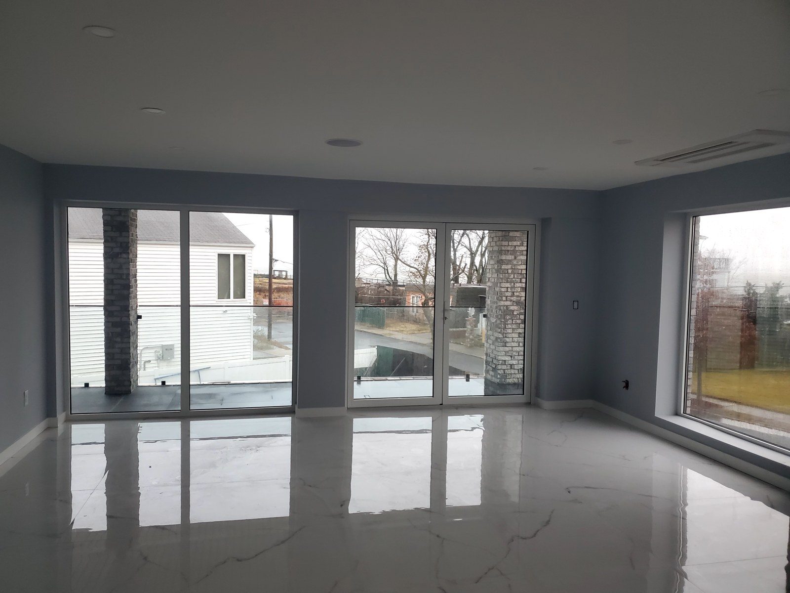 Main room with two pairs of Alutech aluminum glazed doors and a large picture window at 5101 Beach 51st Street, Sea Gate, Brooklyn