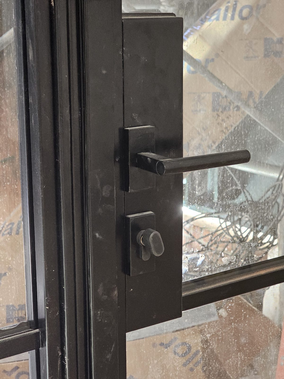 Close view of the black lever handle and lock on a SIMPAS sliding door