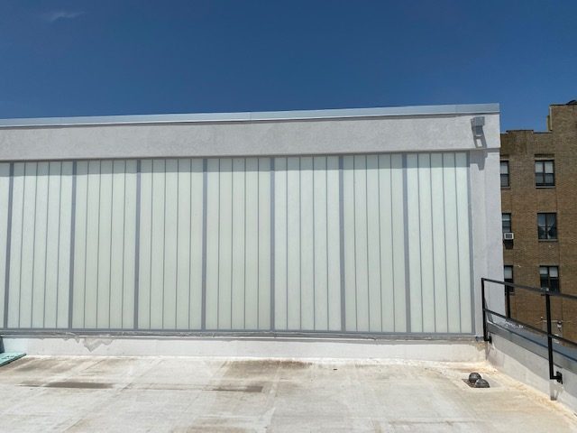 Kalwall translucent wall panels in vertical strips at roof level, 96 Ingraham Street, Brooklyn