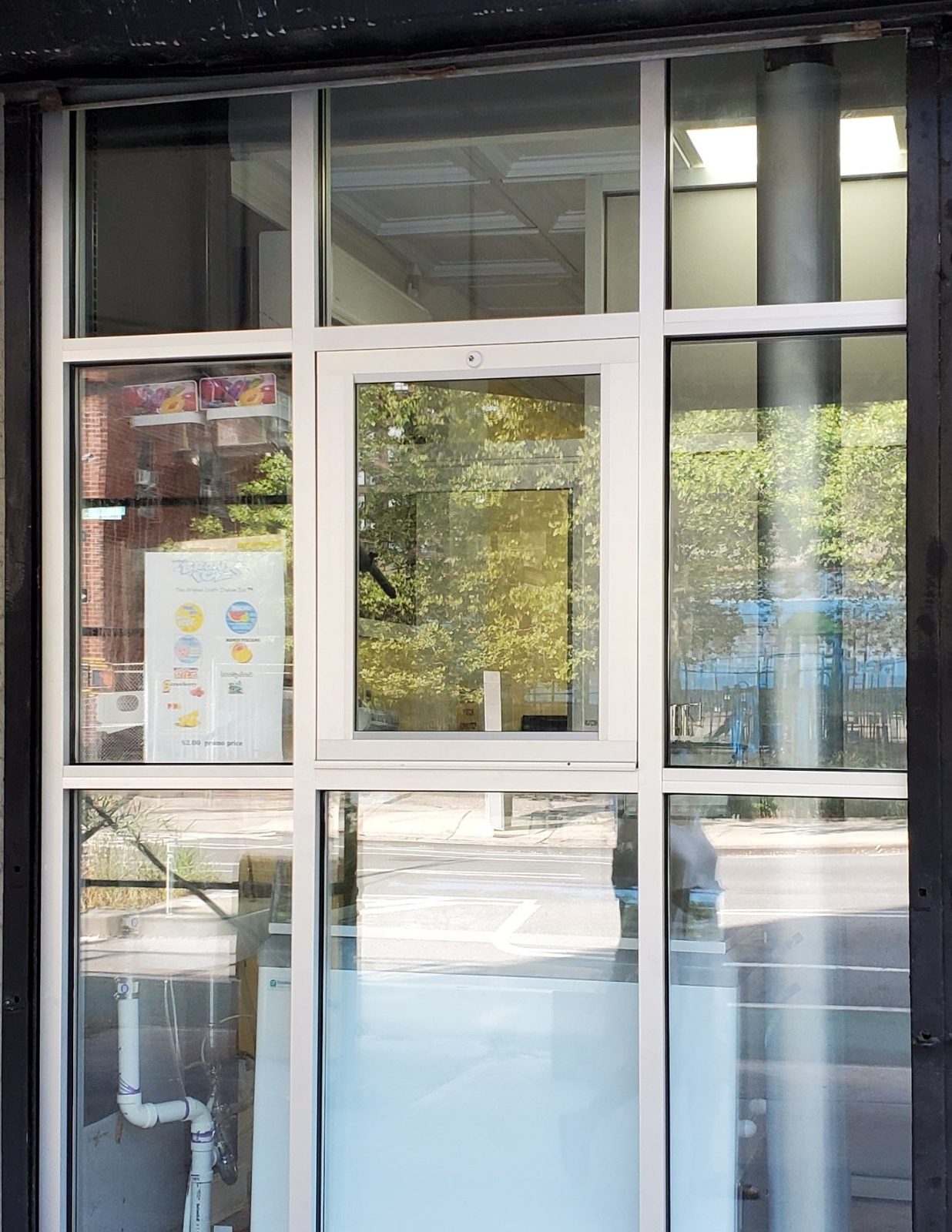 Aluminum tubing storefront section with a business pass-through service window in the center, Amsterdam Avenue, Manhattan