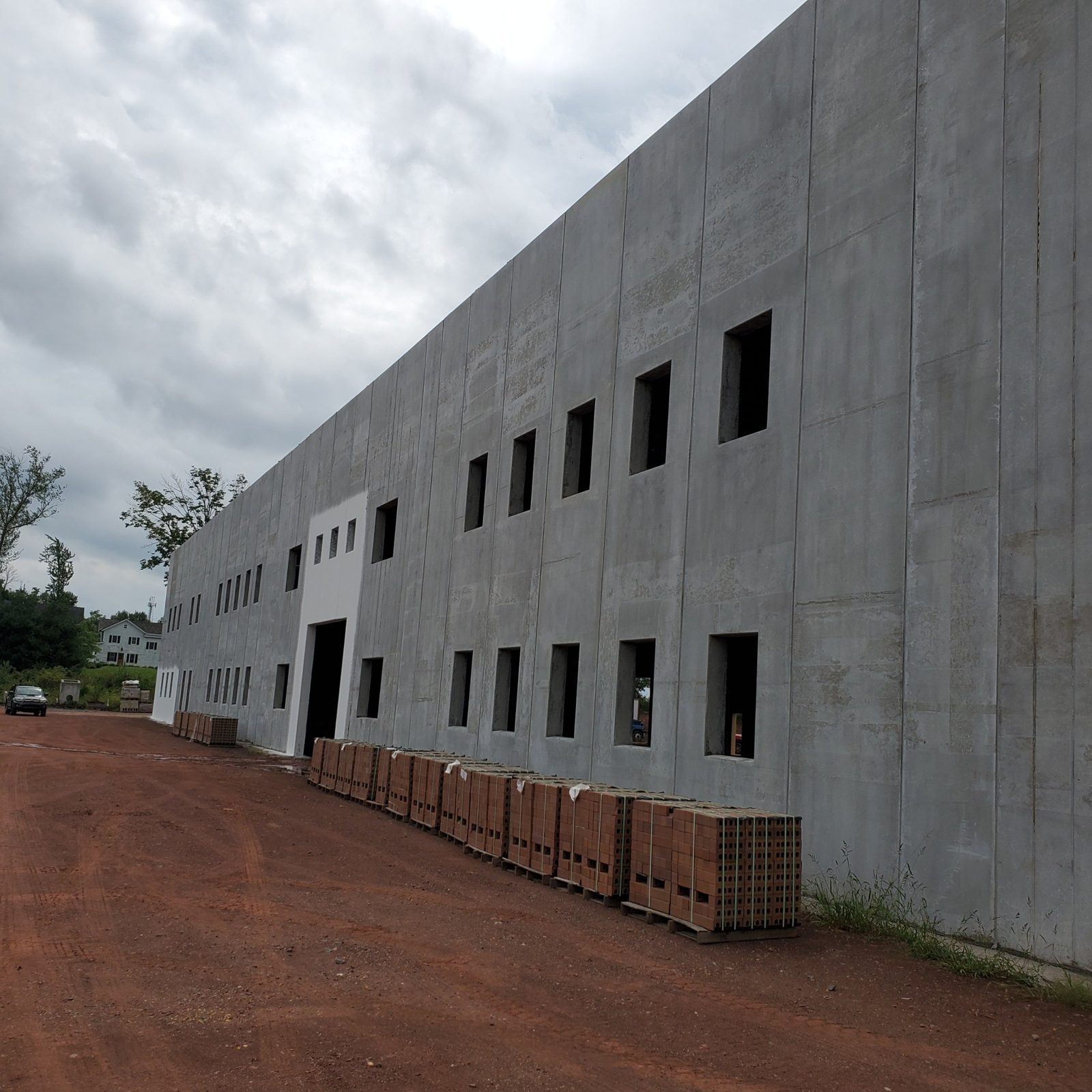 Precast concrete shell of the Central New Jersey warehouse with open window openings, before the facade and windows
