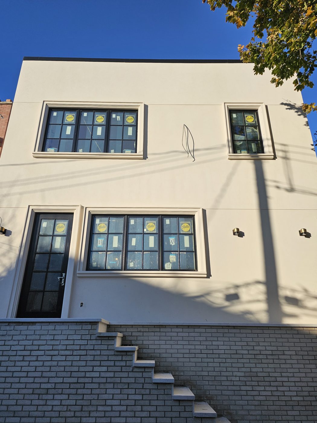 Front elevation of a new Manhattan Beach house with Pella casement windows in cast-stone surrounds