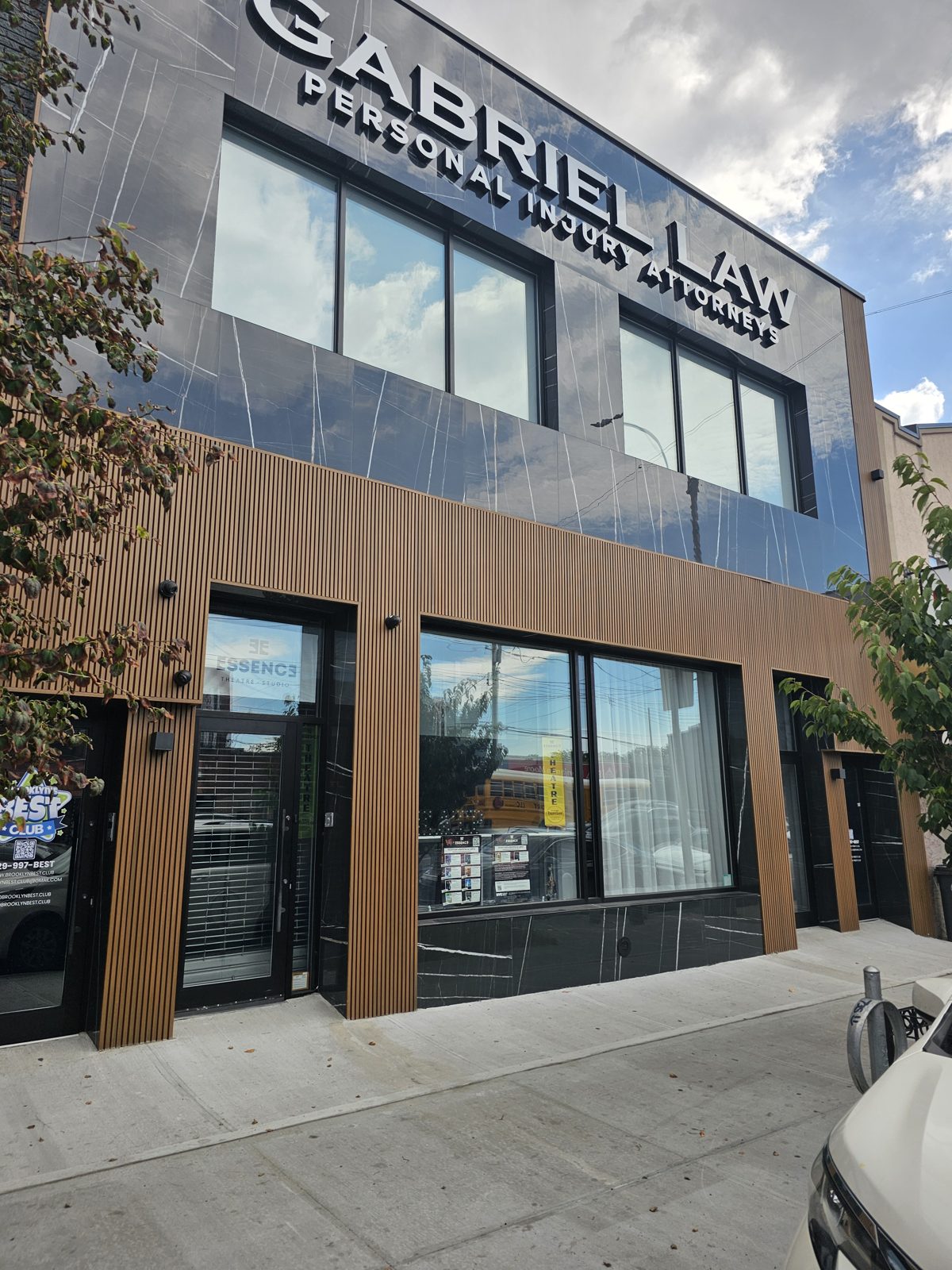 Complete facade on Coney Island Avenue, Brooklyn: aluminum storefront, composite slat cladding, black granite tiles, aluminum capping