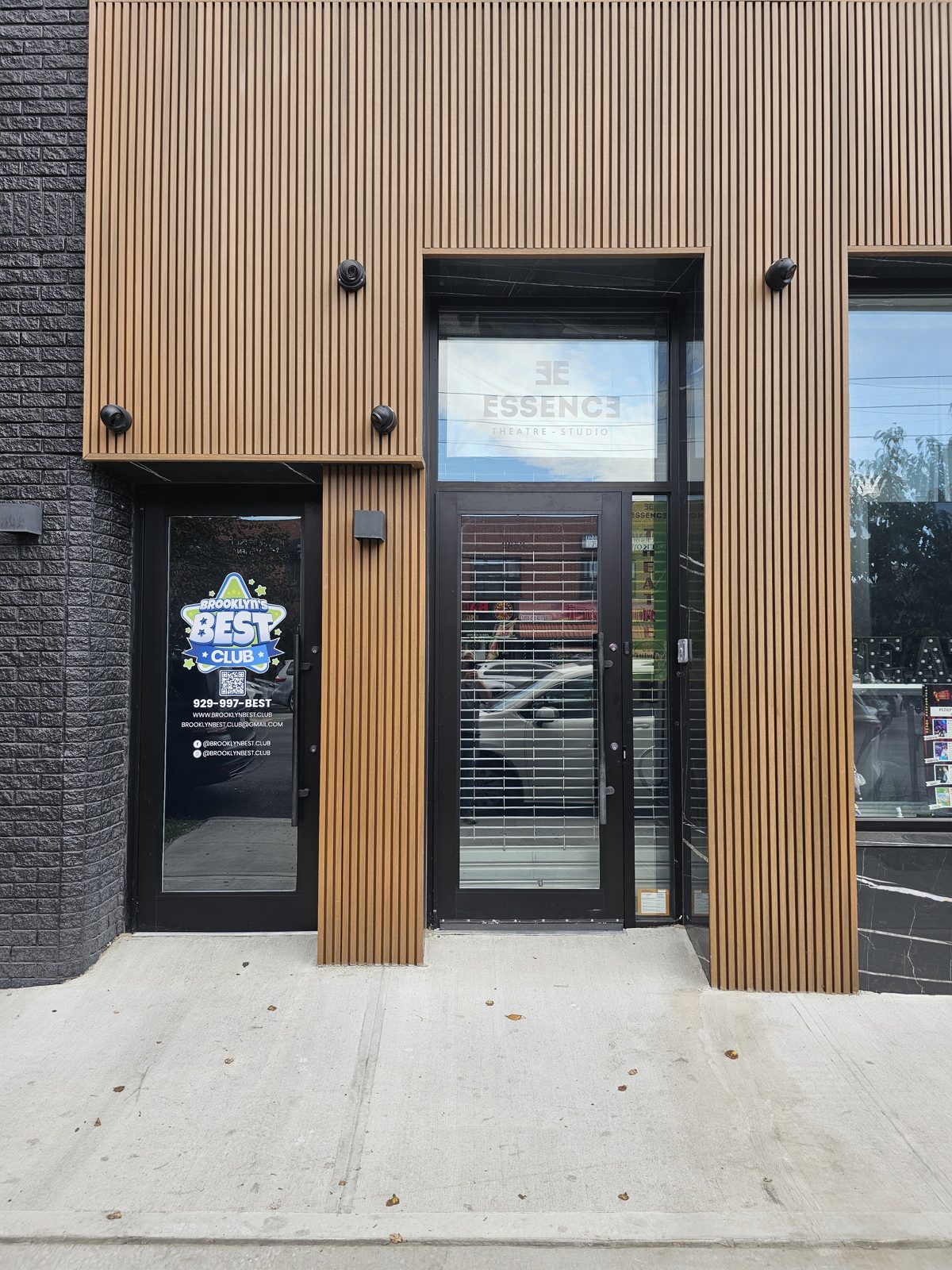 Storefront entrance doors with buzzer access control set in composite slat cladding