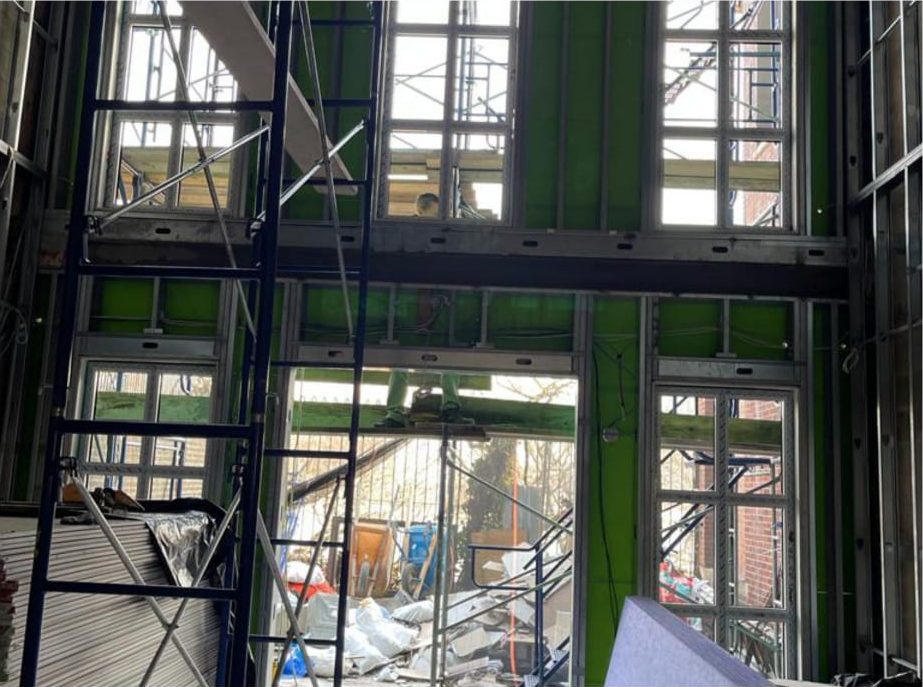 Scaffold inside the double-height hall with windows being installed into the framed openings, Embassy of Tunisia, New York