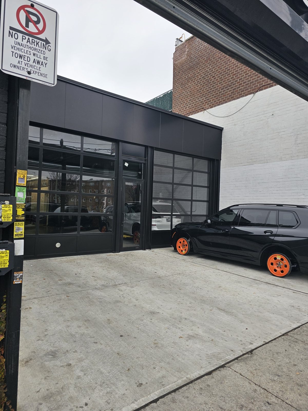 Aluminum composite panel fascia and black aluminum storefront entrance door with transom, Flatbush Avenue Brooklyn