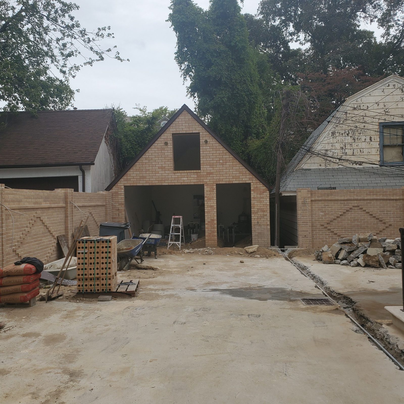 New brick garage with open door openings during construction at a private house in Jamaica Estates, Queens