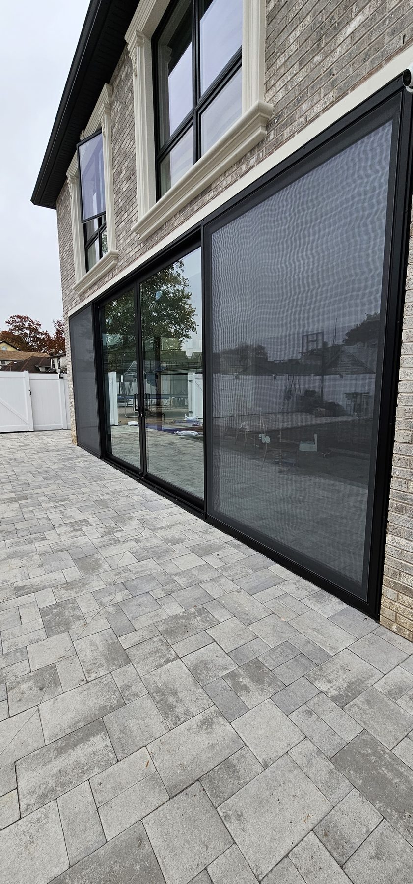 Sliding panels and screen at close range, showing the slim frame sightlines and the flush threshold &mdash; Jamaica Estates, Queens