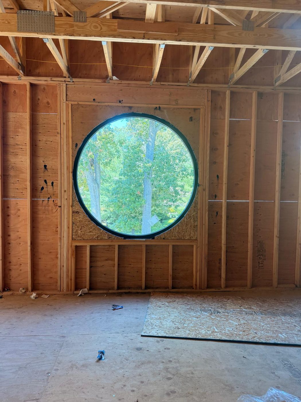 The round window seen from inside during framing, showing the opening set out in timber &mdash; Lakewood, New Jersey