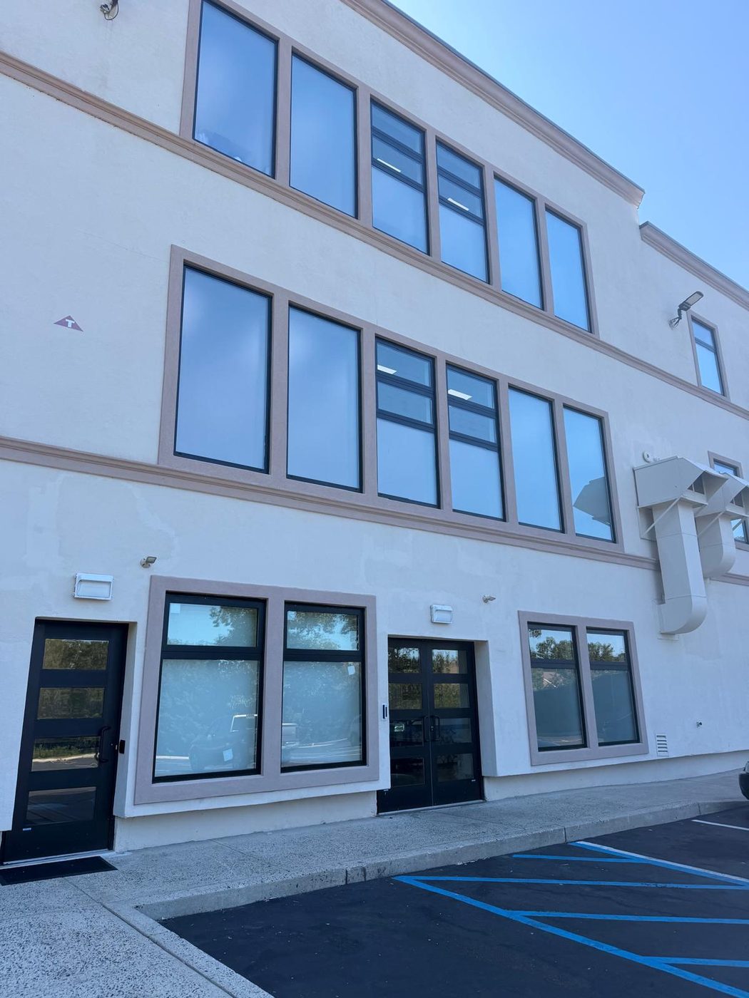 Storefront glazing and upper-floor windows on the same building &mdash; Lakewood, New Jersey